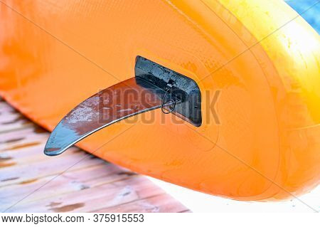 Black Fin On A Orange Sup Board