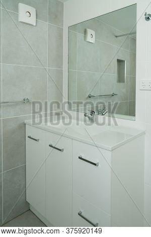Newly Renovated Ensuite Bathroom With Basin, Mirror And Tiled Walls