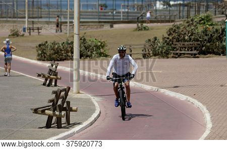 Salvador, Bahia / Brazil - October 13, 2019: Cyclist Is Seen Riding A Bicycle Along The Bike Path Ne