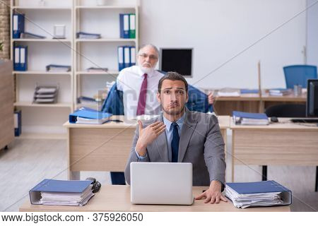 Two male employees working in the office