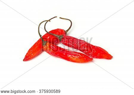Three Red Hot Chili Peppers Isolated On A White Background.