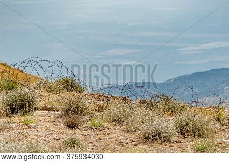 Barbed Wire On The Mount Hermon Hillside Overlooking The Fields Of Lebanon