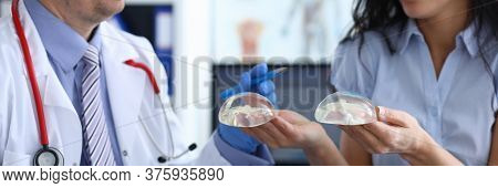 Close-up Of Smiling Lady Holding Implants. Lovely Female Person At Consultation With Professional Do