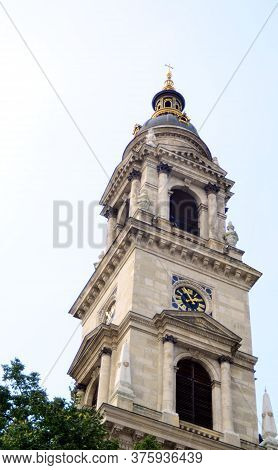 Budapest, Hungary - 09.14.2019: The Dome Of The Tower Of The Cathedral With A Cross And A Round Cloc