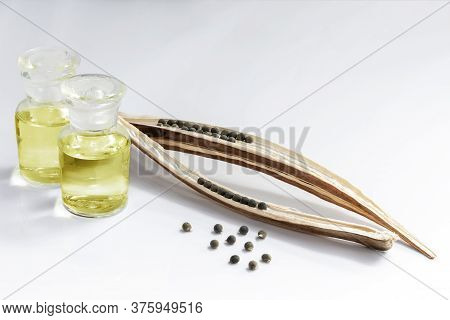 Okra Oil In Glass Bottles And Abelmoschus Esculentus Seed On A White Background, It Is Help Relieve 