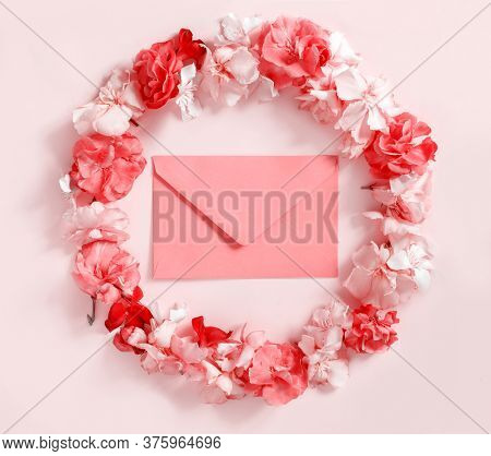 Red Envelope In A Frame Of Pink Flowers Over A Pink Background