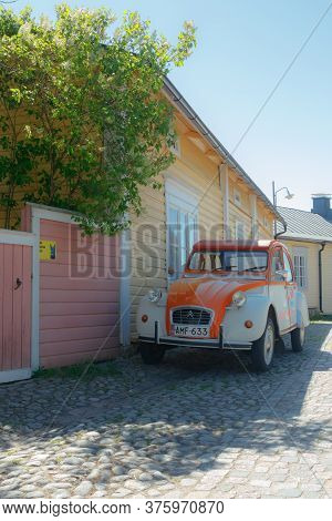 Porvoo, Finland - 3 June 2020: Beautiful Street With Blooming White Lilac And Vintage Car Citroen 2C