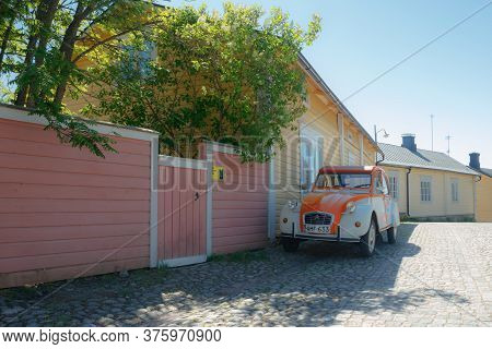 Porvoo, Finland - 3 June 2020: Beautiful Street With Blooming White Lilac And Vintage Car Citroen 2C