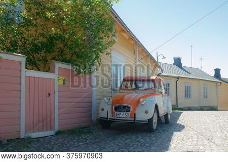 Porvoo, Finland - 3 June 2020: Beautiful Street With Blooming White Lilac And Vintage Car Citroen 2C
