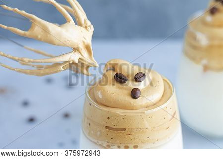 Cooking Summer Dalgon Coffee Ice Drink. Close-up Of Sweet Coffee Foam Next To Whisk