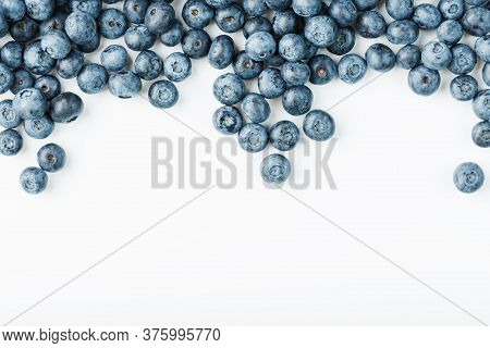 Tasty Blueberries Fruit Are Scattered On A White Background. Frame
