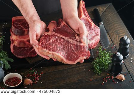 Steak Beef Meat. Chef Cutting Steak Beef. Mans Hands Hold Raw Steak Tomahawk On Rustic Wooden Cuttin