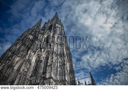Cologne Cathedral Seen From Below With Blue Sky. Cologne Cathedral, Or Kolner Dom, Is The Main Landm