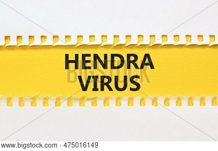 Hendra Virus Symbol. Concept Words Hendra Virus On Yellow Paper. Beautiful Yellow Table White Backgr