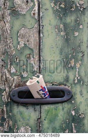 Lido Di Venezia, Italy - August 19 2022: Mailbox Slit With Italian Newspaper In A Vintage Old Door W