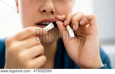 Woman Chewing Wet Moist Nicotine Tobacco Snus Product