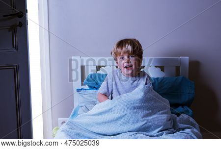 Happy Boy Wake Up Sit In The Bed Covered By Blanket