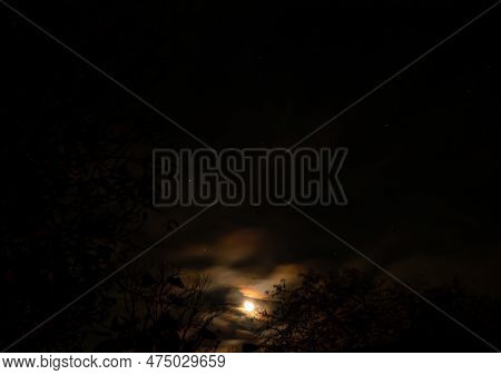 The Moon On The Background Of The Cloudy Night Sky. The Moon Is On The Night Horizon. Cloudy Weather