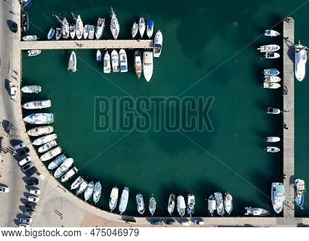 Drone Aerial Scenery Of A Fishing Port. Fishing Boats And Yachts Moored In The Harbour. Zygi Marina 