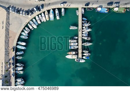 Drone Aerial Scenery Of A Fishing Port. Fishing Boats And Yachts Moored In The Harbour. Zygi Marina 