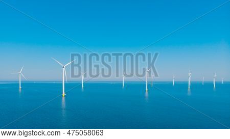 Windmill Park With A Blue Sky On A Sunny Day In The Netherlands, Biggest Windmill Park In The Ocean
