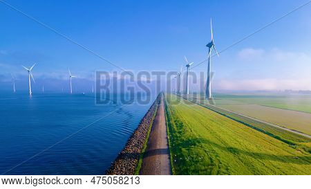 Windmill Park With A Blue Sky On A Sunny Day In The Netherlands, Biggest Windmill Park In The Ocean