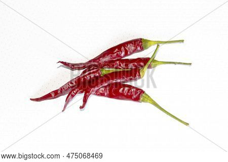 A Lot Of Hot Pepper On A White Background. A Few Chili Peppers On White. Pepper Is Red With Green Ta