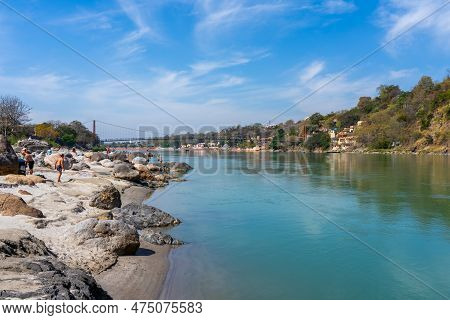 Rishikesh, Uttarakhand, India - 28.03.2023: Beautiful River Ganga In Rishikesh Surrounded By Ashrame