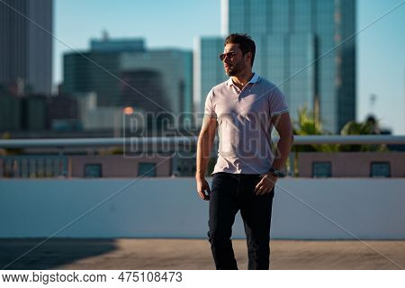 Portrait Of Handsome Confident Stylish Man In Big City. Sexy Man In Casual Clothes Posing On The Str