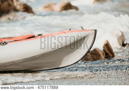 Happy Couple Kayaks In An Inflatable Kayak On The Sea At Sunset. Couple Kanoeing In The Sea Near The