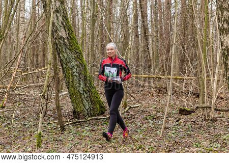 Grodno, Belarus - 26 March, 2023: Cute Elderly Caucasian Women Wearing Sportswear Running Through A 