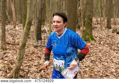 Cute Elderly Caucasian Women Wearing Sportswear Running Through A Forest