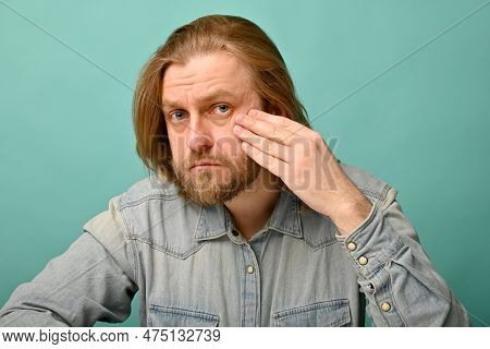 Man In Front Of Mirrror Looking At His Wrinkles