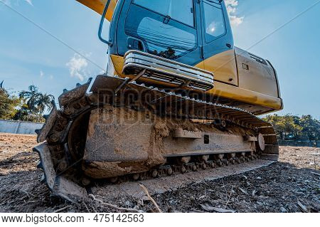 Excavator With Shovel Digs The Ground For The Foundation At Constuction Area.