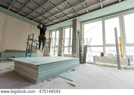 Repairman Repairing Ceiling, Ceiling Panels Broken And Damage From Water Leakage , Home Maintenance 