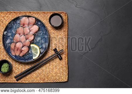 Raw Mackerel Slices, Ice Cubes And Lemon Served With Vasabi On Dark Table, Top View With Space For T