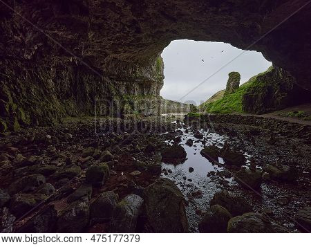 Entrance Of Smoo Cave At The Coastline Of The Atlantic Ocean In Northern Scotland.