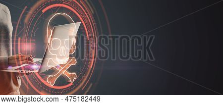 Hacker Using Notebook With Digital Red Skull On Wide Dark Background With Mock Up Place. Ransomeware
