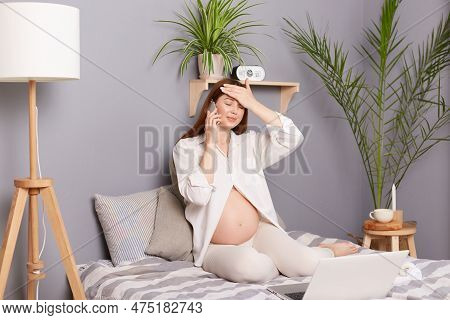 Pregnancy Health. Phone Consultation. Unhealthy Sick Pregnant Brown Haired Caucasian Woman Sitting I