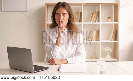 Work Secret. Elegant Woman. Keep Silence. Conspirator Smiling Lady In White Shirt Sitting Desk Holdi