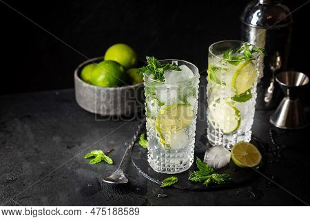 Glass Of Iced Lemonade With Lime And Mint, Cold Summer Drink On Dark Background