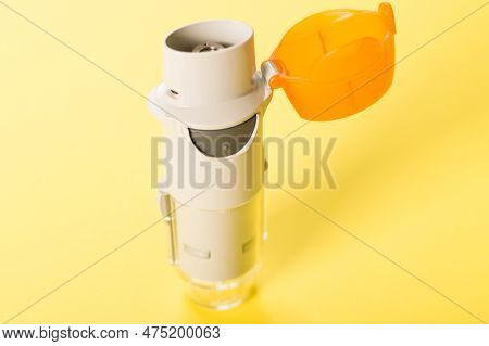 Inhaler For Asthma On The Yellow Background. Violations Of The Respiratory Functions Of The Lungs. M