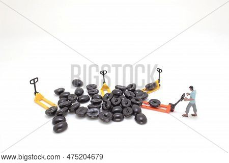 A Worker Using Pallet Jack To Lift Heavy Roasted Coffee Bean