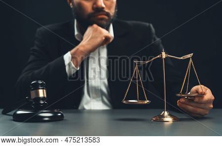 Focus Symbols Of Justice, Gavel Hammer And Scale Balance On Blurred Background Of Thoughtful Lawyer 