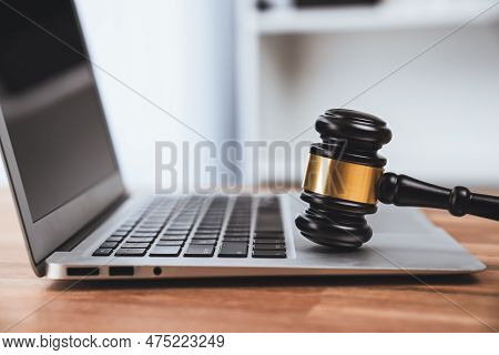 Closeup Black Wooden Gavel Hammer With Laptop On Desk In Law Firm Or Lawyer Office Background As Jus