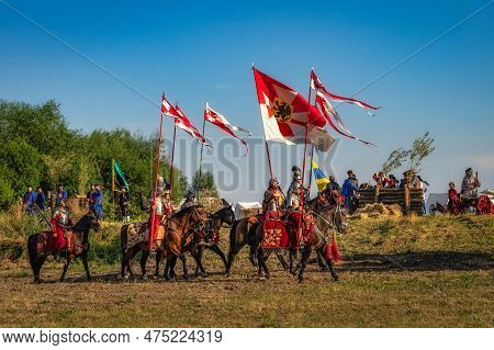 Gniew, Poland, Aug 2020 Polish Hors Cavalry, Hussars, Riding On A Battlefield With Pendants And Flag