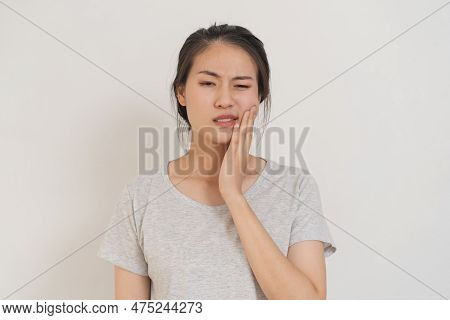 Closing Eyes Asian Young Woman Touching Cheek, Face Expression From Toothache, Tooth Decay Or Sensit