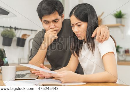 Stressed Asian Young Couple Family, Wife And Husband Confused By Calculate Expense From Invoice Or B