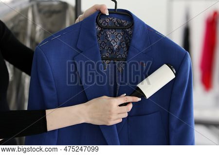 Skilled Woman Removes Pellets From Blue Woolen Coat With Roller Holding In Hands. Female Worker Prov