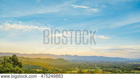 Dramatic Sunset Over Mountain Landscape. Beautiful Landscape Foggy Hills Twilight Time. Blue Golden